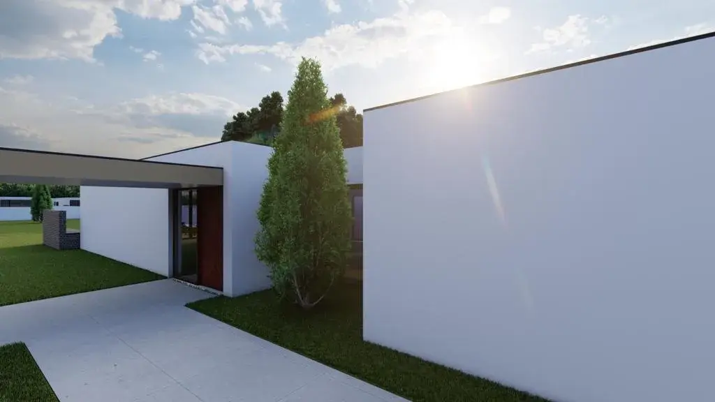 Pátio e volumes brancos da moradia — Eco Village Enxomil